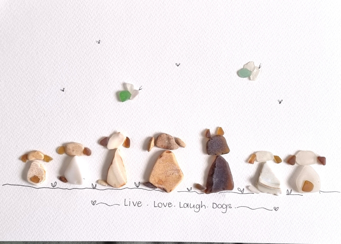 Seaglass artwork of several dogs with the words written 'live love laugh dogs'