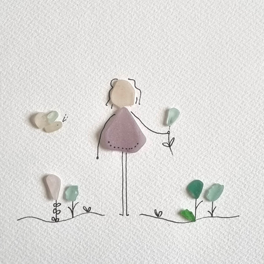 Seaglass artwork of a lady in her garden